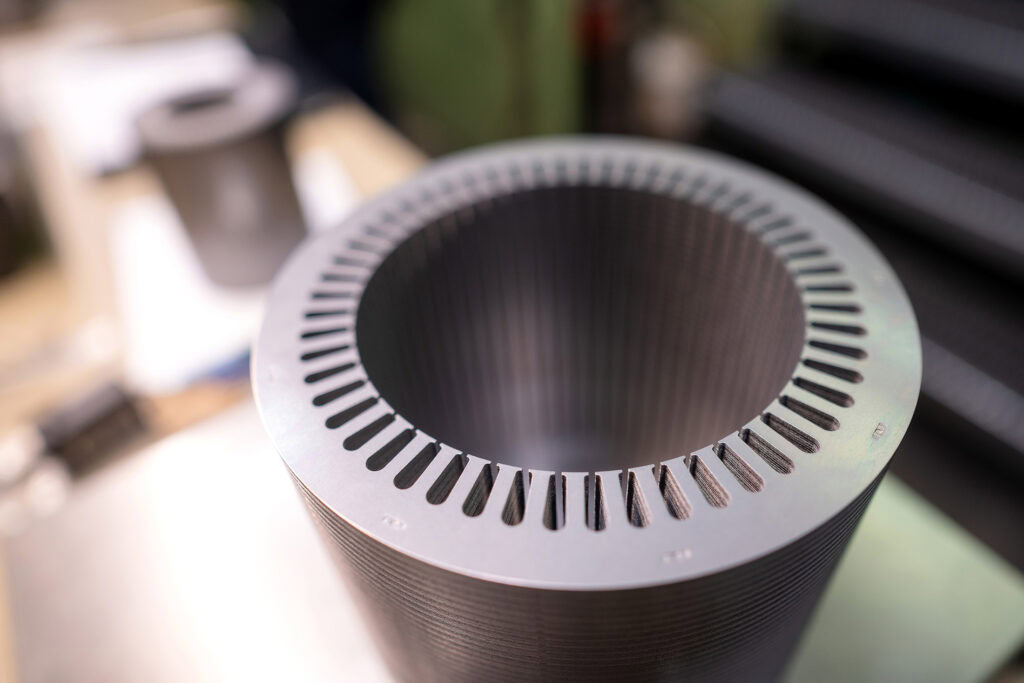 Close-up of a stamped rotor or stator core stack, highlighting precision-cut laminations used in power generation applications.